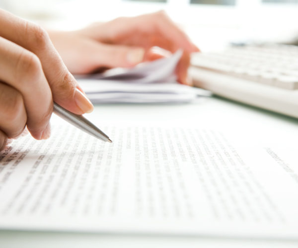 Close-up of secretarys hands doing paperwork