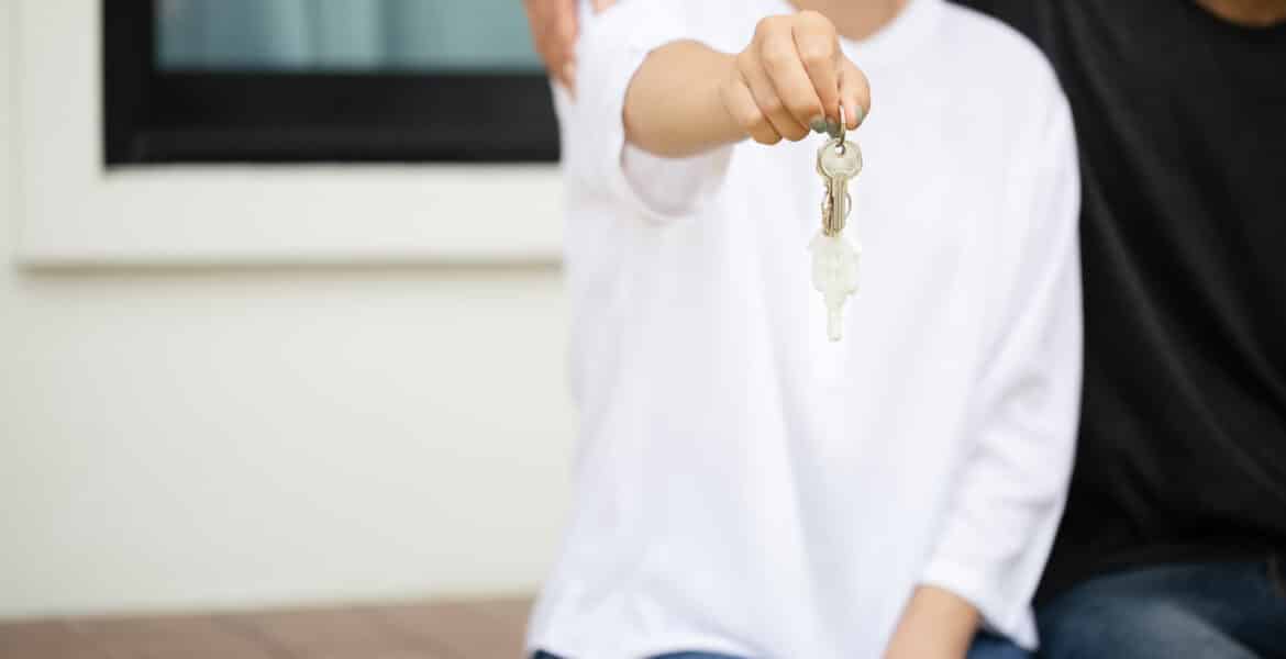 Close up focus of happy young asian couple showing a keys